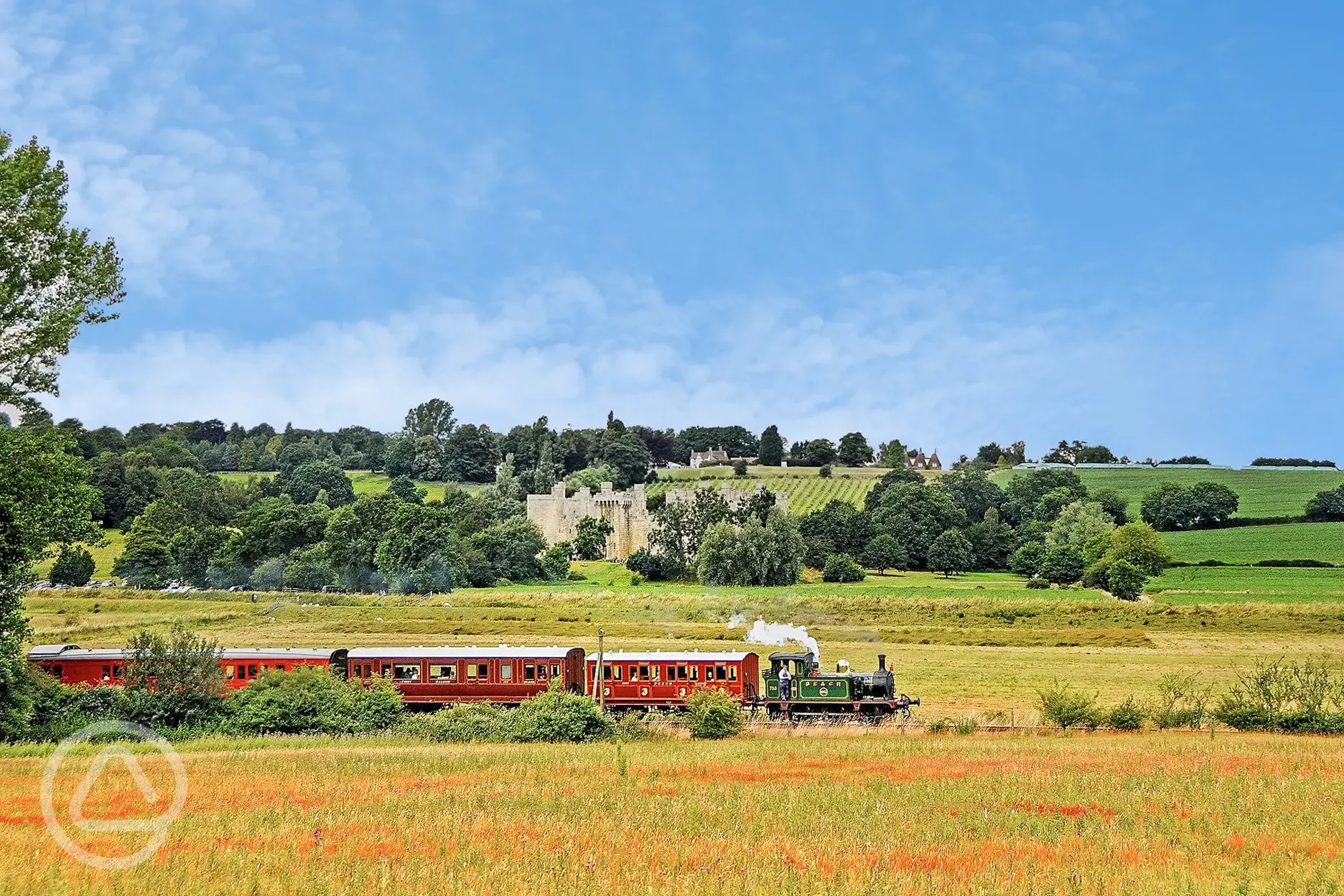 Steam train passing Bodiam Castle