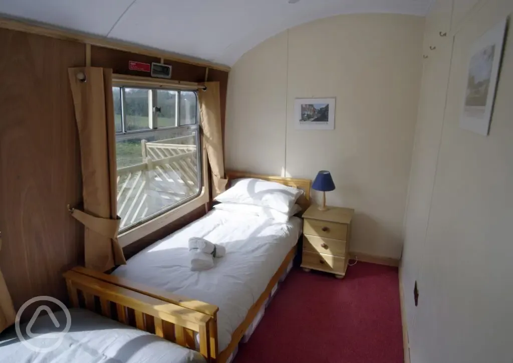 Single bed bedroom in glamping coach