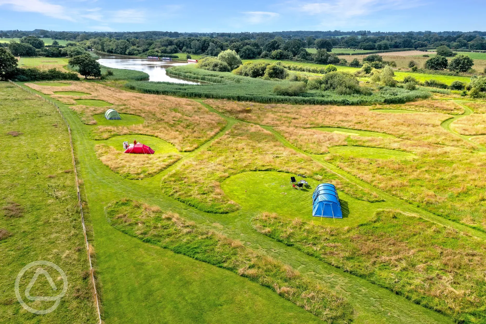 Aerial of the non electric grass tent pitches beside Oakwood Marina