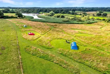 Aerial of the non electric grass tent pitches beside Oakwood Marina