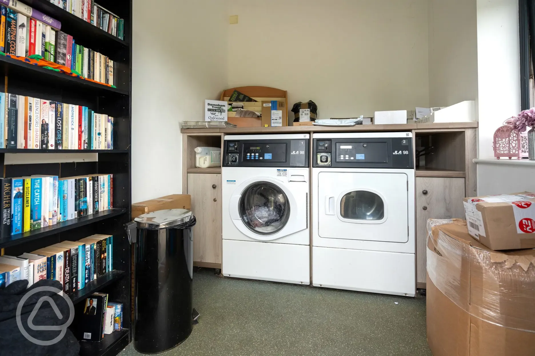 Laundry and information room with washing machine and tumble dryer