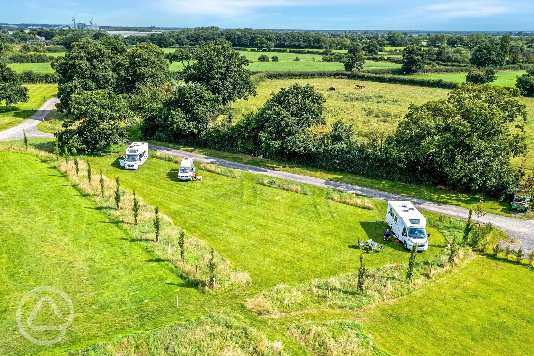 Aerial of the electric grass touring pitches with 16 amp hook up (3m x 8m)