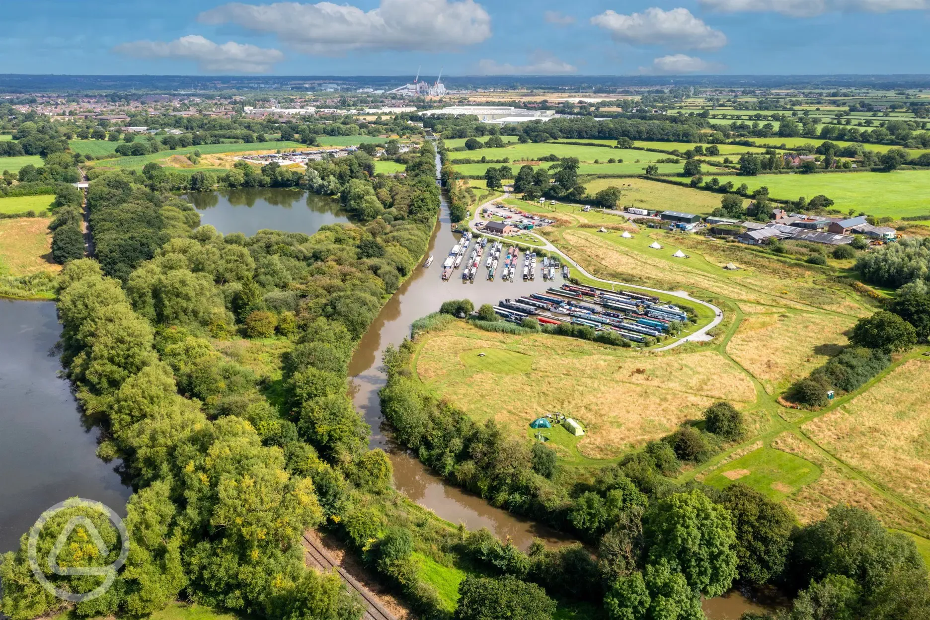 Aerial of Oakwood Marina grass pitches and bell tents