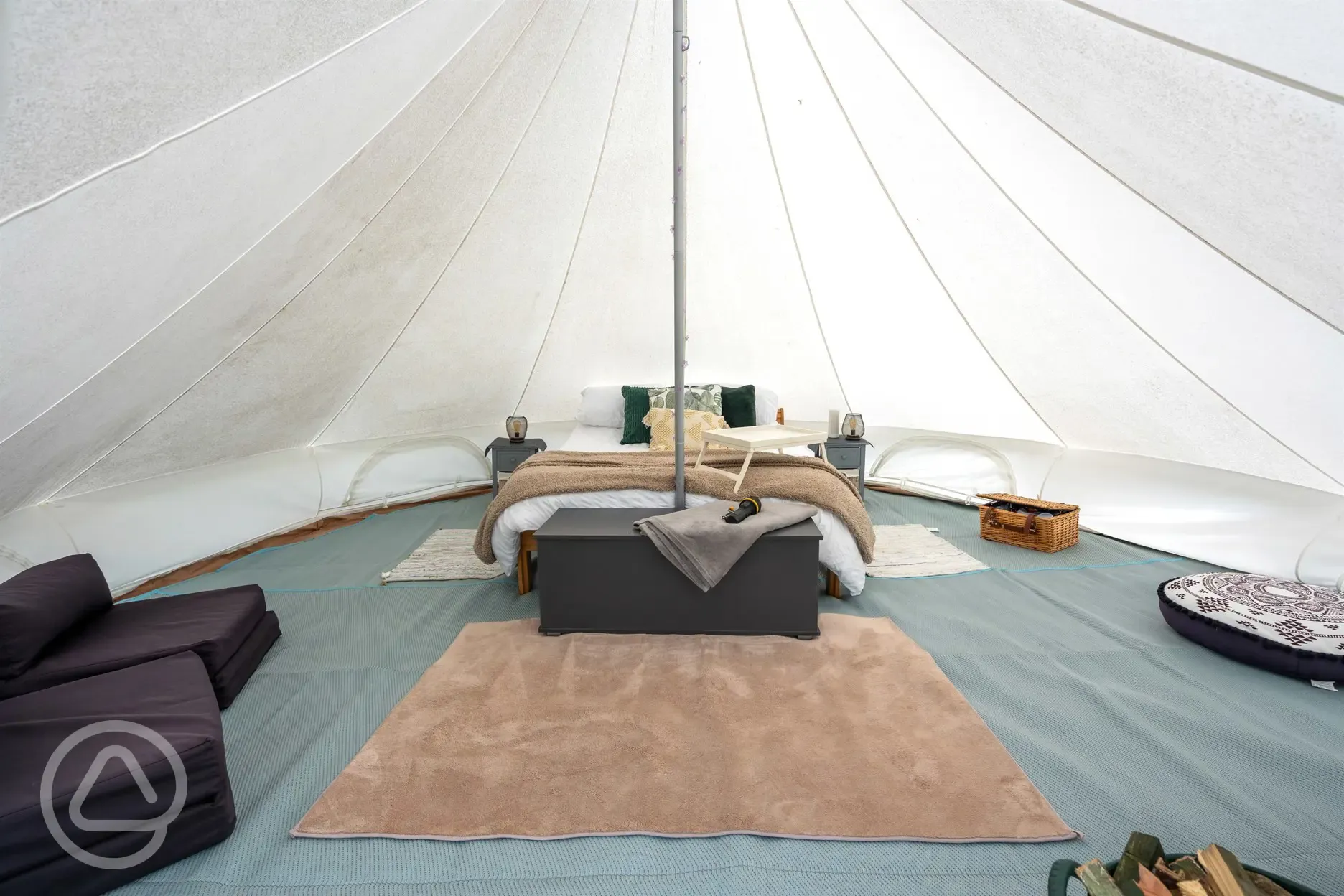 Bell tent double bed and furnishings at Oakwood Marina