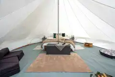 Bell tent double bed and furnishings at Oakwood Marina