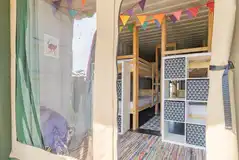 Glamping cabin interior with bunks beds and storage Glamping cabin interior with bunks beds and storage