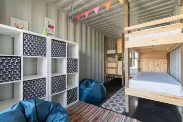 Glamping cabin interior with bunks beds and storage