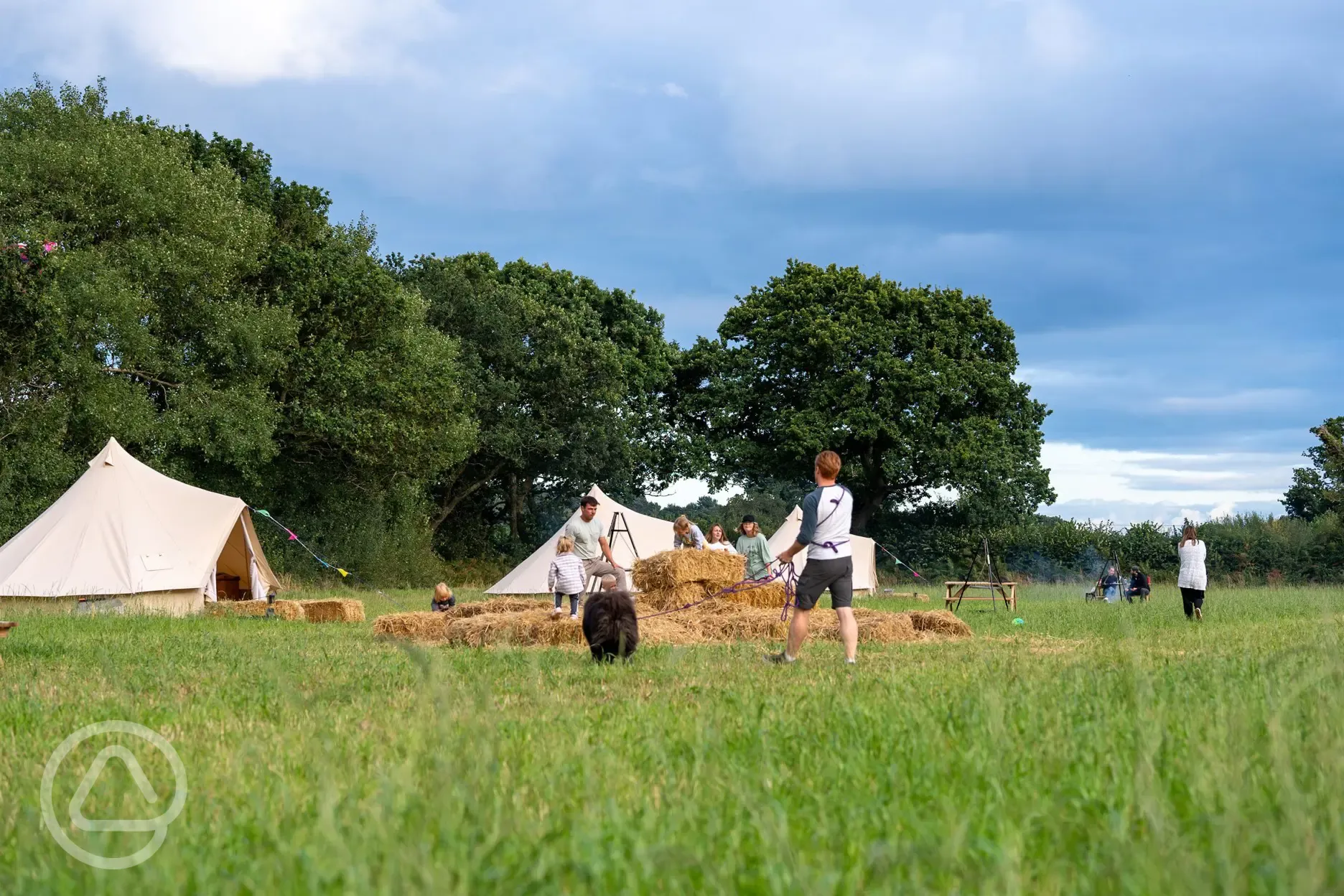 Children playing outside the bell tents