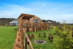 The Heron's Nest exterior with seating area and a fire pit