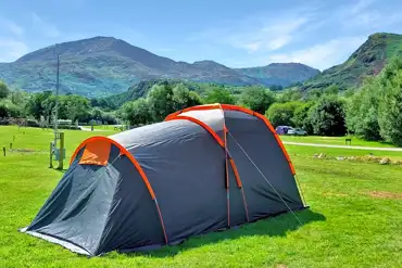 Electric grass tent and campervan pitches at Cae Du with mountain views