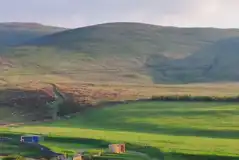 Non electric grass pitches beside the stream onsite