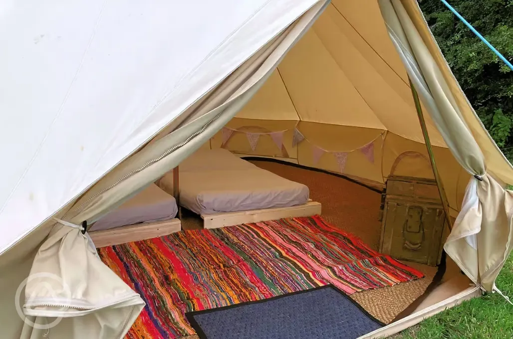 Three person bell tent interior with an extra airbed available
