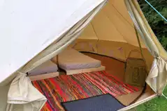 Three person bell tent interior with an extra airbed available Three person bell tent interior with an extra airbed available