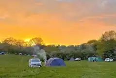 Non electric grass tent pitches at sunset