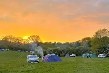 Non electric grass tent pitches at sunset