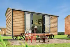Shepherd's hut exterior with outdoor seating Shepherd's hut exterior with outdoor seating
