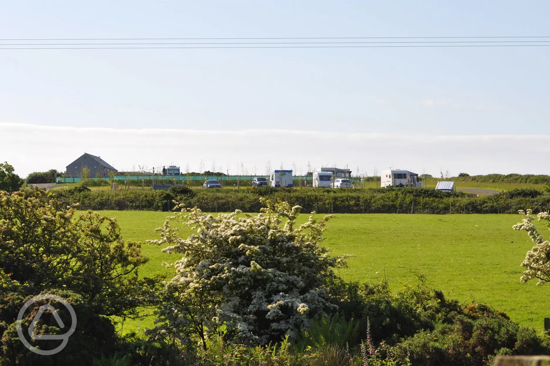 Grass pitches with touring pitches behind