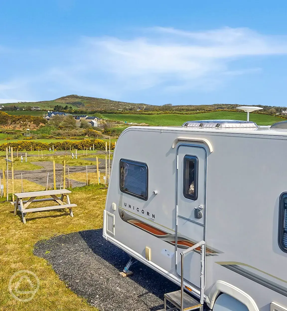 Grass and hardstanding touring pitch with optional electric and country views