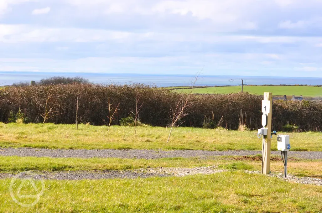 Electric hardstanding touring pitches and sea views