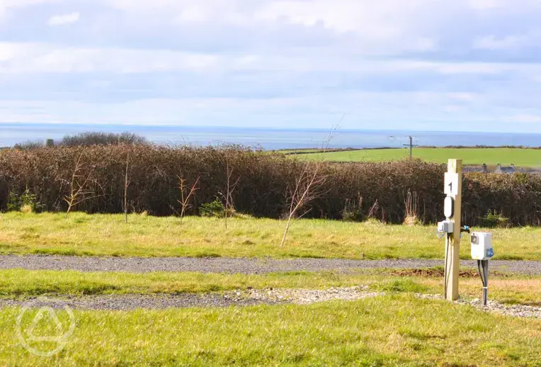 Electric hardstanding touring pitches and sea views