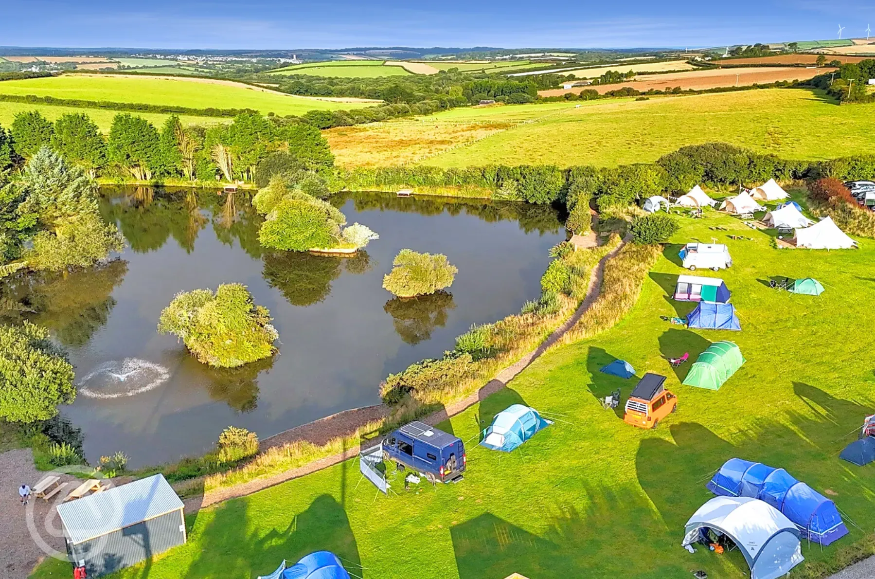 View of Tregonetha Lake with camping pitches by the water View of Tregonetha Lake with camping pitches by the water