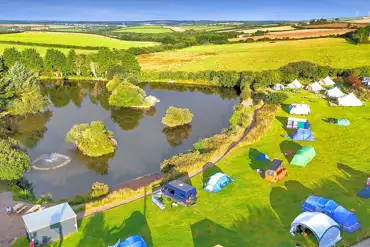 View of Tregonetha Lake with camping pitches by the water