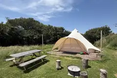 Unfurnished bell tent with a fire pit and seating (bring your own bedding) 