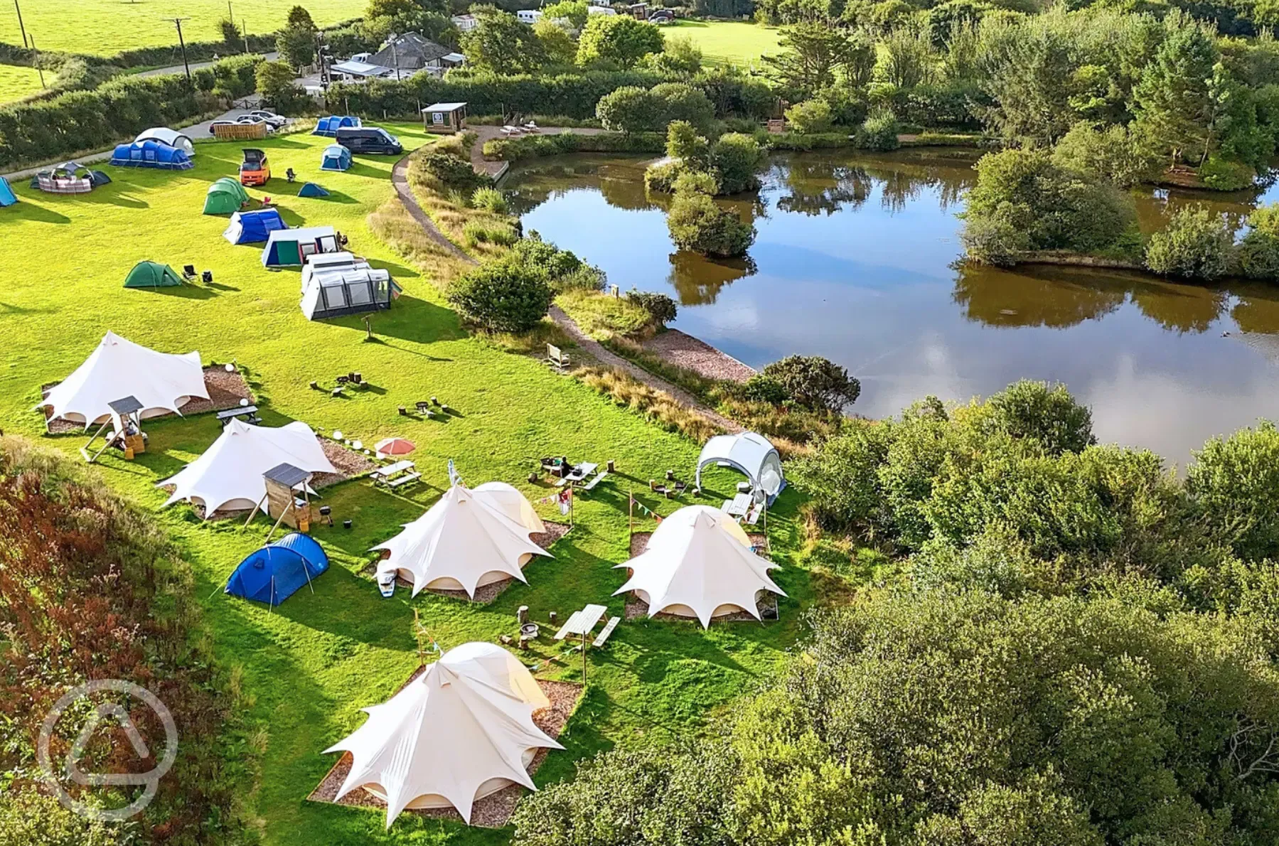 Bell tents and camping pitches by the lake edge Bell tents and camping pitches by the lake edge