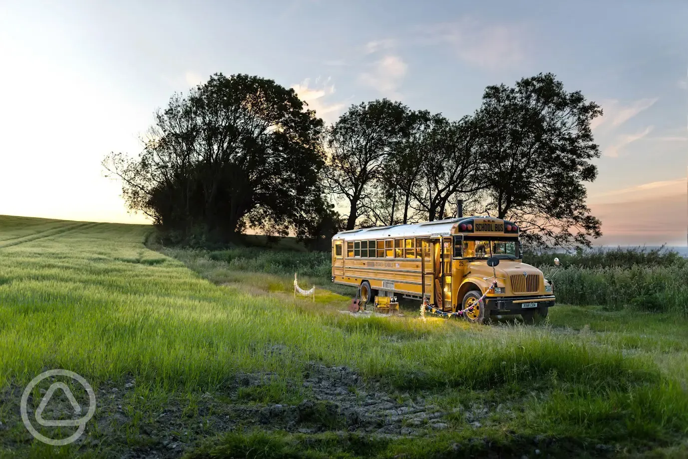 Glamping school bus at sunset