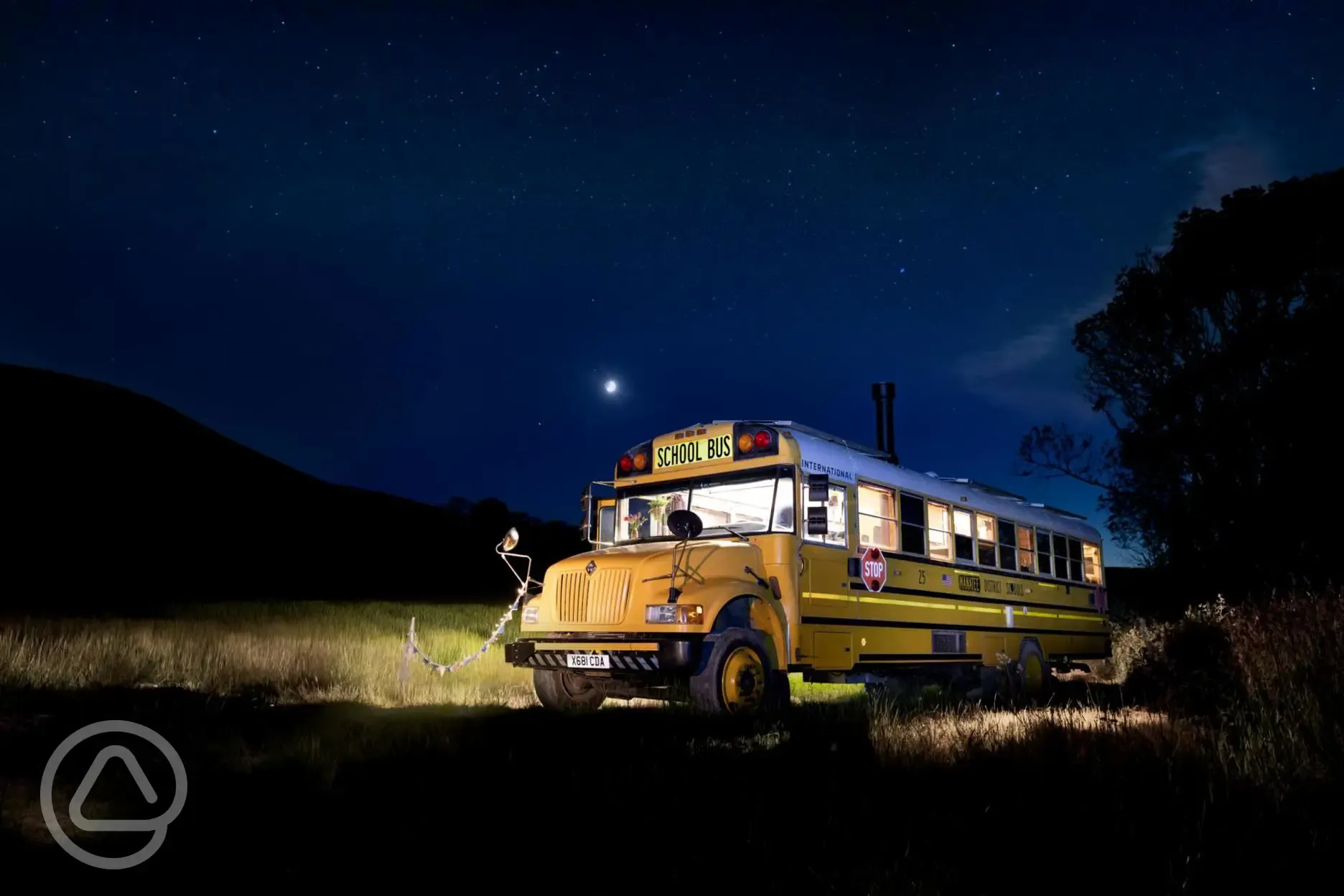 Glamping school bus at night