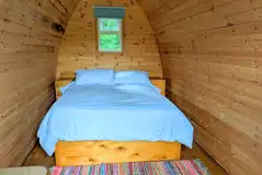 Camping pod interior with double bed Camping pod interior with double bed