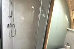 Ensuite in the glamping pods with a toilet, shower, and handwashing sink