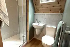 Ensuite in the glamping pods with a toilet, shower, and handwashing sink
