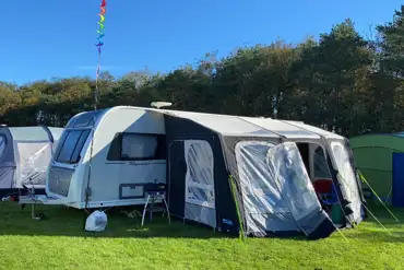 Caravan on a grass pitch with space for an awning at Pointer Farm Campsite
