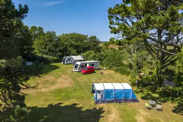 Aerial of the electric grass pitches, surrounded by hedges and trees