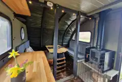 Dining area, seating, and wood-burning stove in the Foot O'Skiddaw