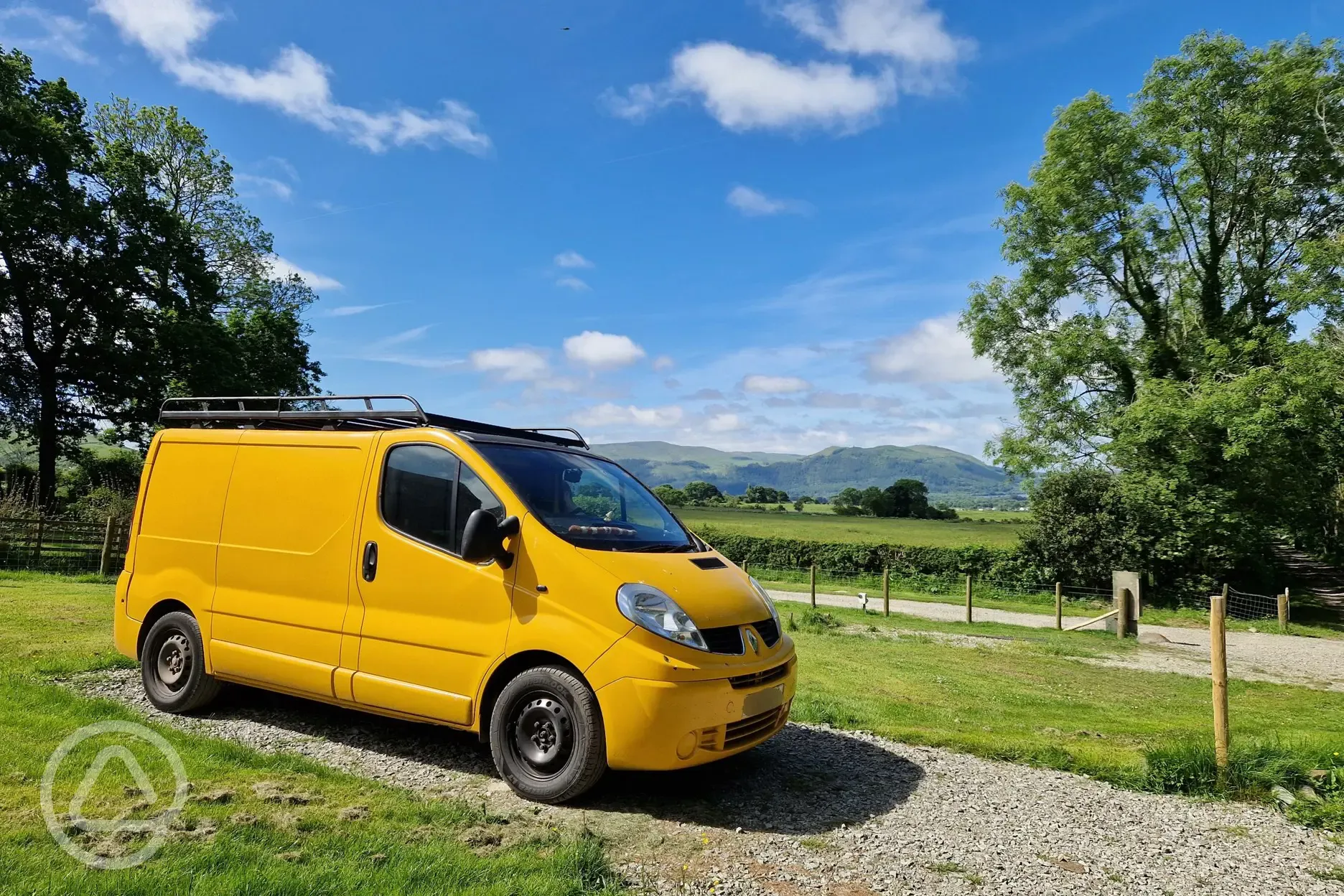 VW campervan on an electric hardstanding pitch