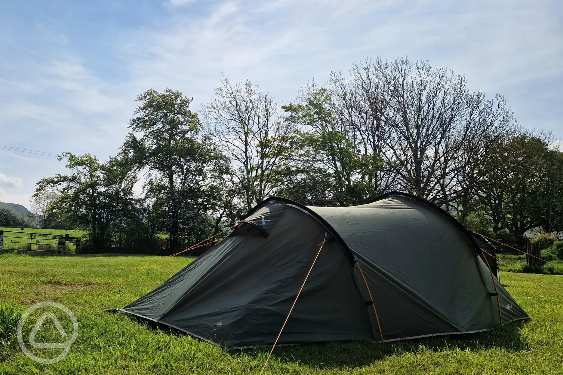 A tent on a backpacker grass pitches at Kestrel Lodge Campsite