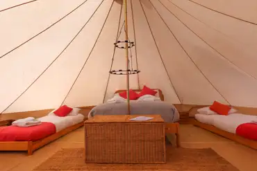 Bell tent with a double bed and two single beds