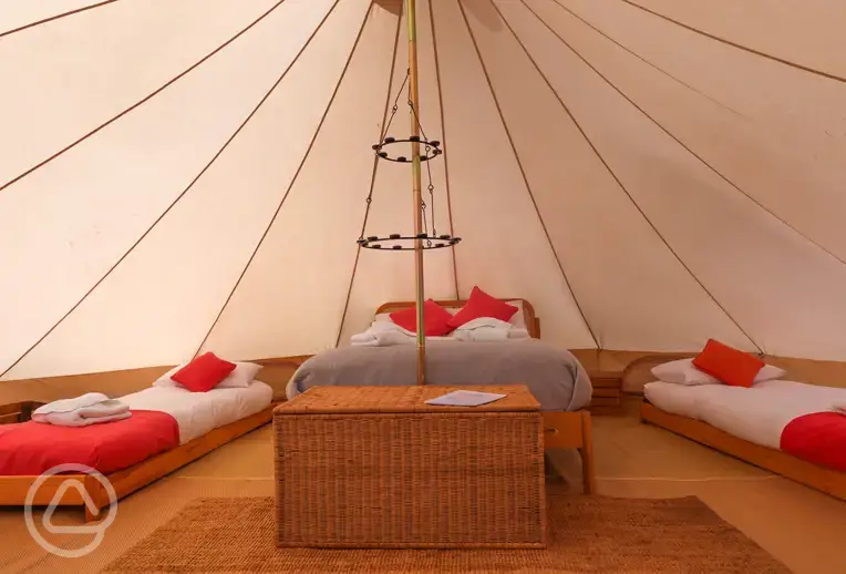 Bell tent with a double bed and two single beds