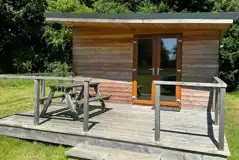 Fully furnished glamping lodge with private decking and picnic benches
