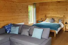 Glamping lodge king size bed and L-shaped sofa bed (bedding provided)