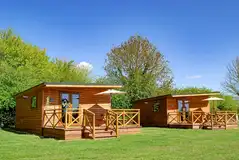 Fully furnished glamping lodges with private decking and picnic benches