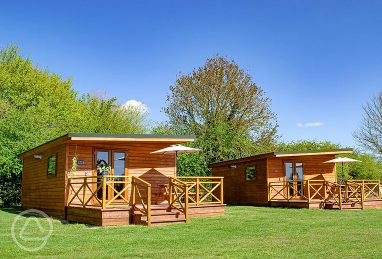 Fully furnished glamping lodges with private decking and picnic benches