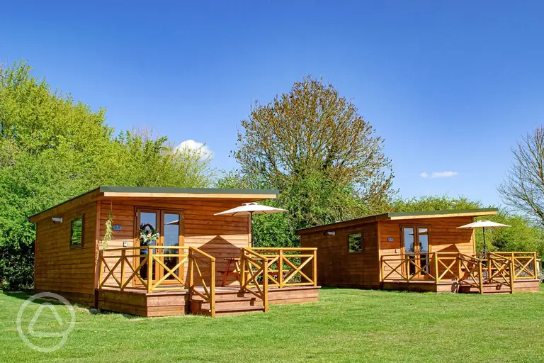 Fully furnished glamping lodges with private decking and picnic benches