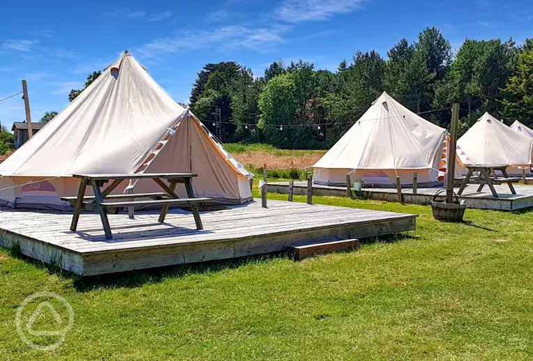 Furnished bell tents with private decking and picnic benches at Cherry Burton