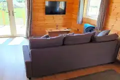 Glamping lodge L-shaped sofa and TV