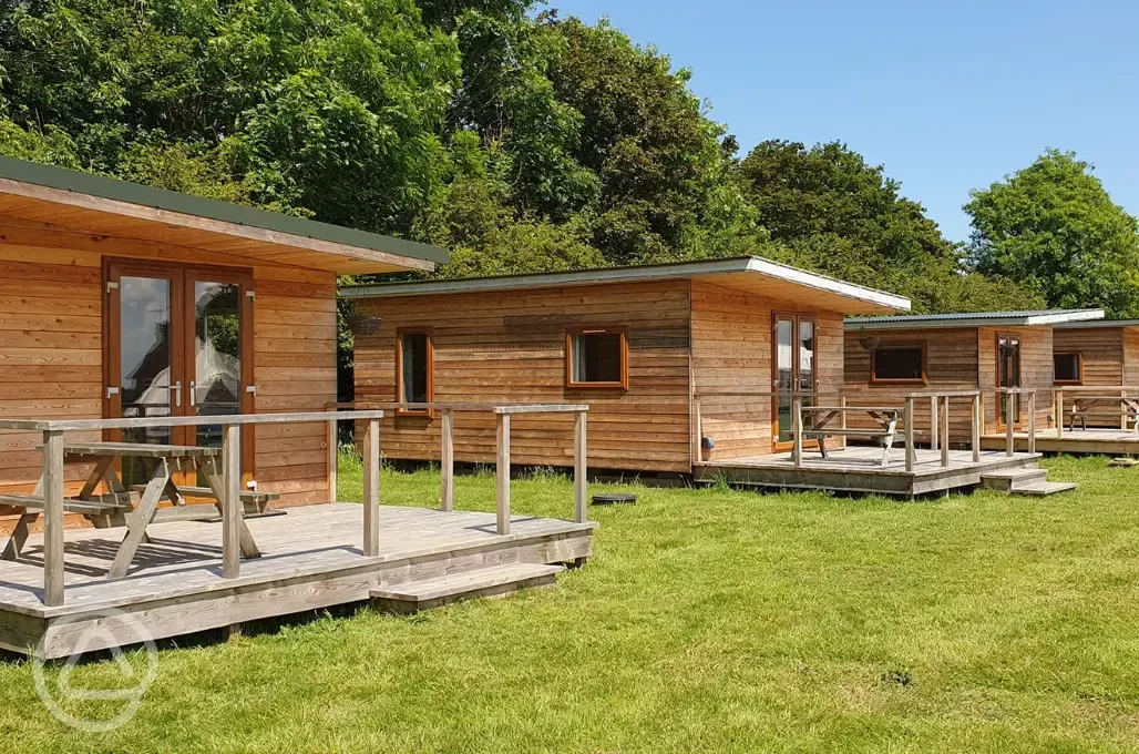 Fully furnished glamping lodge with private decking and picnic benches