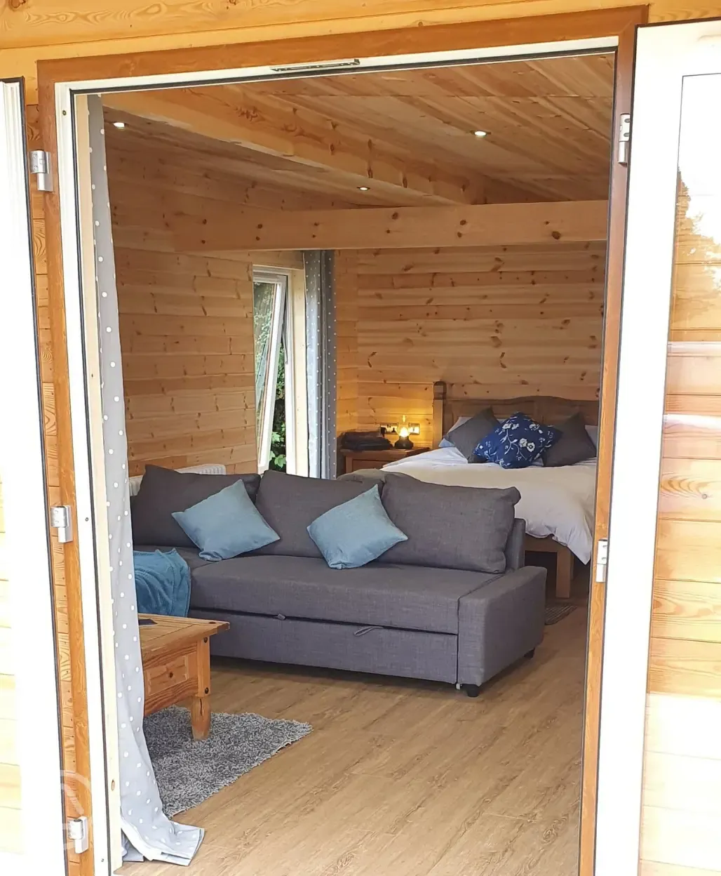 Glamping lodge king size bed and L-shaped sofa bed (bedding provided)