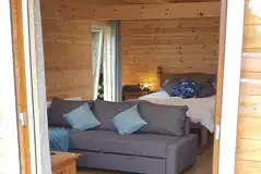 Glamping lodge king size bed and L-shaped sofa bed (bedding provided)